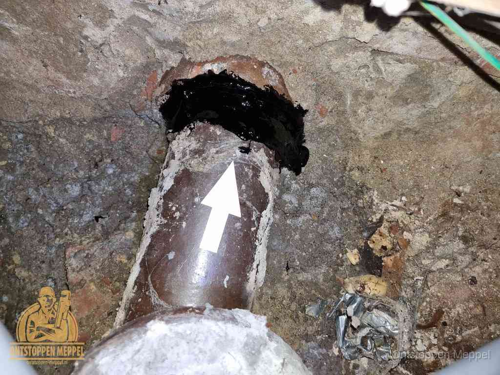 Een oude gres rioolbuis met een beschadigde koppeling onder de vloer, oorzaak van terugkerende structurele wc-problemen in Meppel Een oude gres rioolbuis met een beschadigde koppeling onder de vloer, oorzaak van terugkerende structurele wc-problemen in Meppel